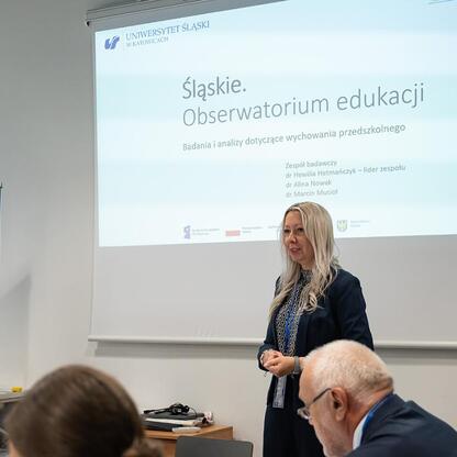 Podpis pod zdjęciem: Przedstawicielka Uniwersytetu Śląskiego prezentuje wyniki badań edukacji przedszkolnej na Śląskim Kongresie Oświaty. (wygenerowano przez AI)
