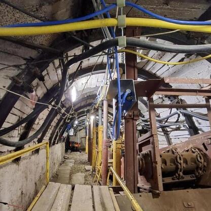 Wnętrze tunelu lub podziemnej infrastruktury, przypominające przemysłowe lub górnicze ujęcie. (wygenerowano przez AI)